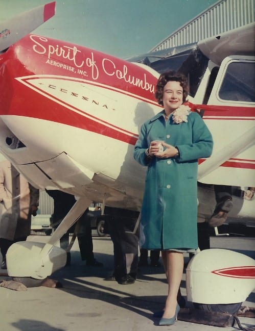 Jerrie Mock posing in front of Spirit of Columbus red and white plane. first round-the-world solo at Port Columbus