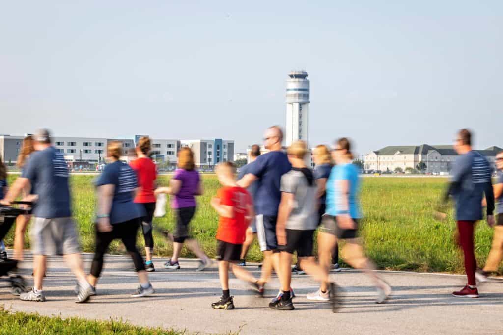 Group of people walking the runway at John Glenn International Airport 5k event