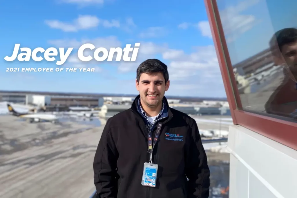 Jacey Conti, 2021 CRAA employee of the year. Portrait with CMH airfield in the background on cold winter day.