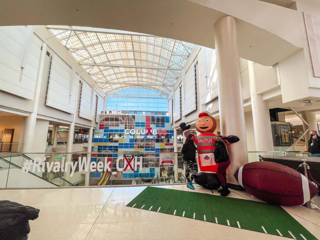 Rivalry week at CMH terminal building display with blow up football and Brutus
