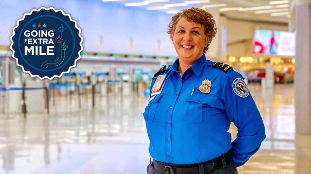 Smiling TSA Agent posing in the ticketing area at John Glenn International Airport