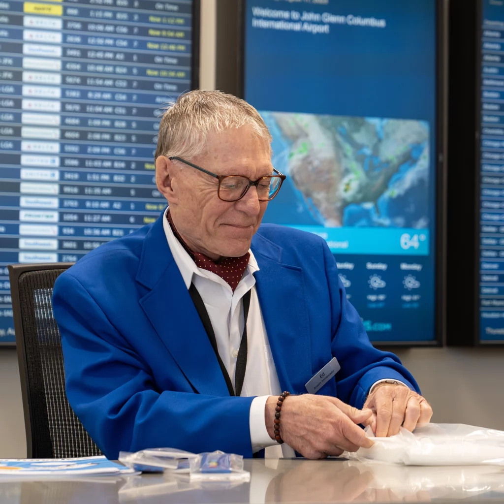 Information desk ambassadors wear a blue jacket at CMH Airport.