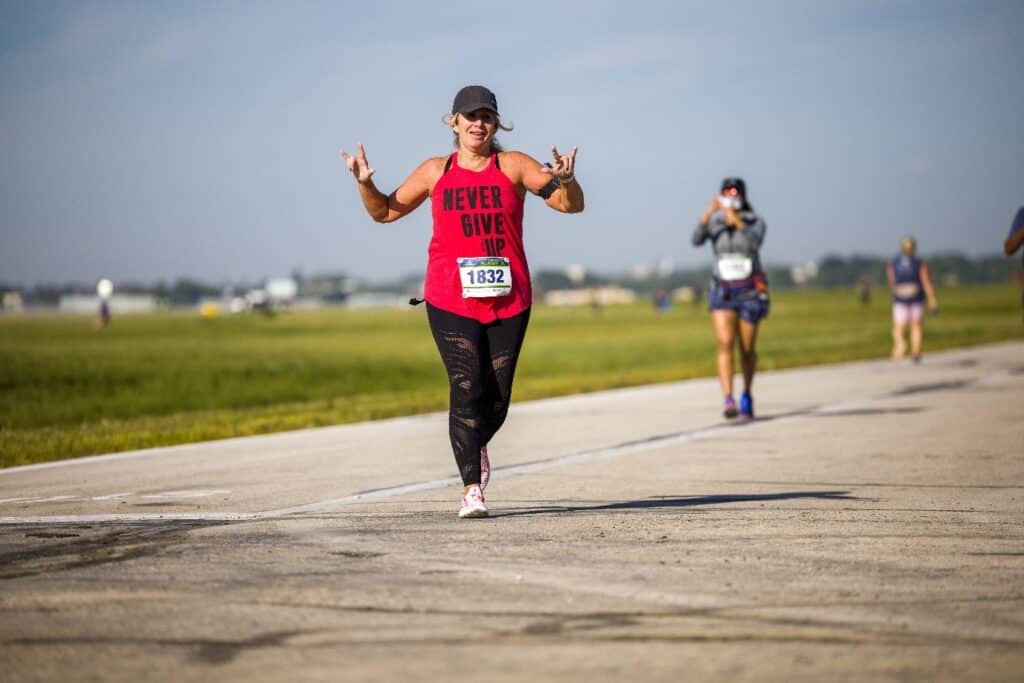 Racer crossing the finish link at CMH Runway 5k