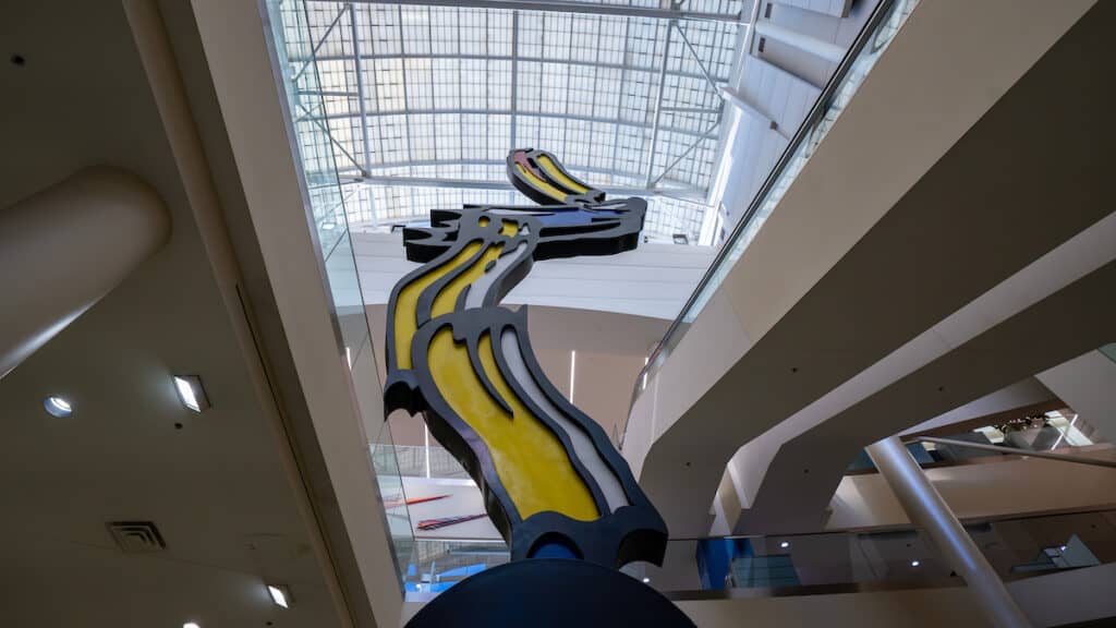 A large yellow and black sculpture in the atrium of John Glenn International, Columbus Airports.