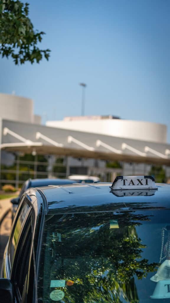 A taxi parked in front of John Glenn International CMH, under the supervision of Columbus Regional Airport Authority.