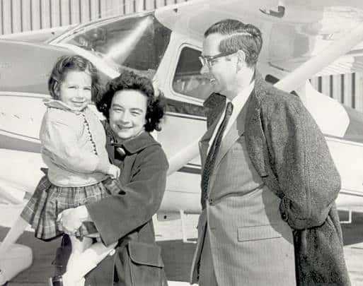 Mock family and child in front of an airplane at John Glenn International.