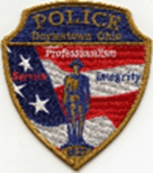 A badge with the words "police department club" from John Glenn International Airport.