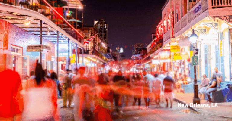 Timelapse of pedestrians moving around the French Quarter in New Orleans at night.