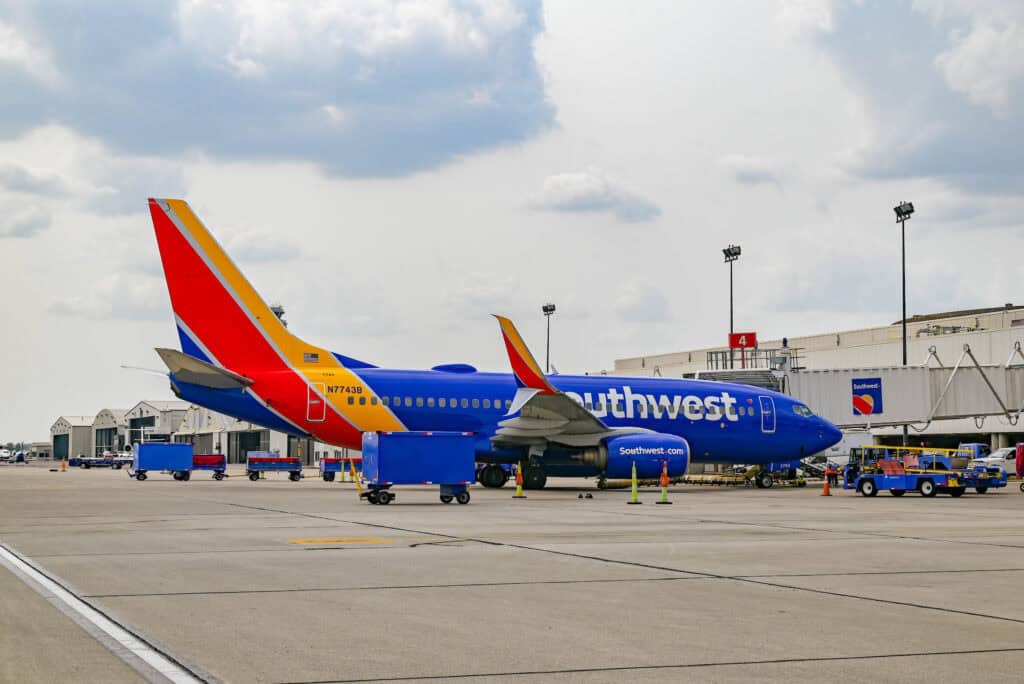 A Southwest Airlines Boeing 737 sits at the gate in Columbus, Ohio under a cloudy sky.