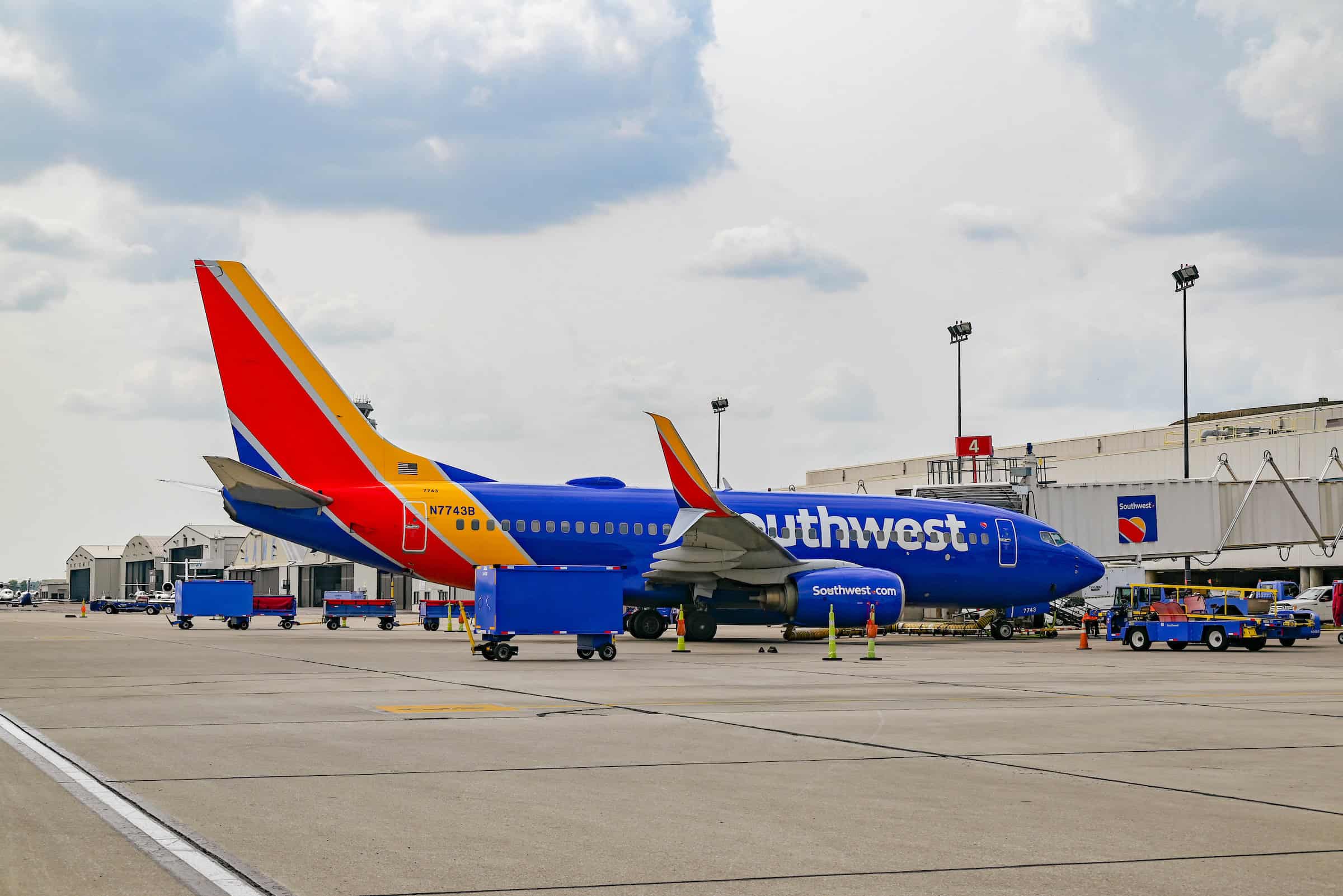 A Southwest Airlines Boeing 737 sits at the gate in Columbus, Ohio under a cloudy sky.
