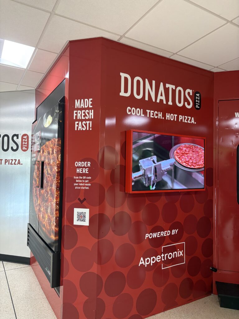 Dining, shopping & amenities 26 Donatos pizza roboto kiosk with a screen showing how the pizza is made.