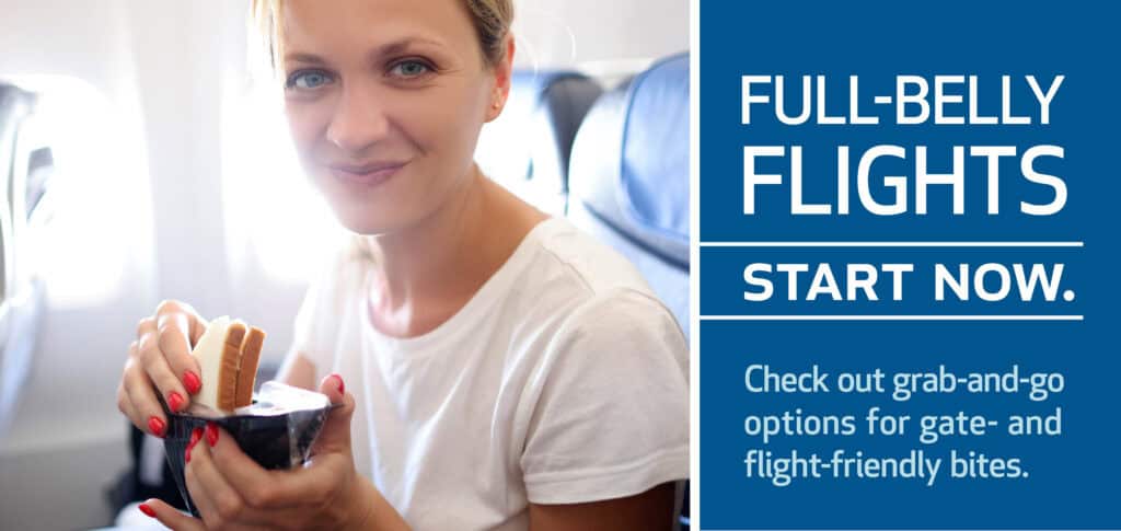 Smiling person enjoying a snack on an airplane, with text promoting 'FULL-BELLY FLIGHTS START NOW' and encouraging travelers to check out grab-and-go options for gate- and flight-friendly bites.