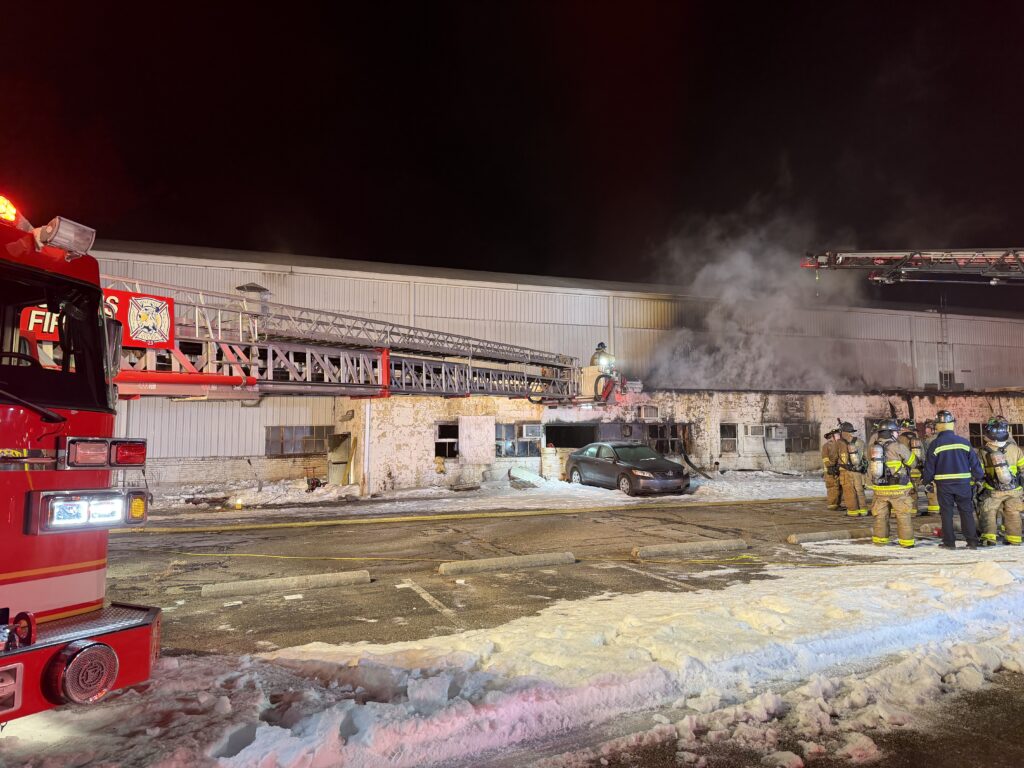 Fire crews fight a fire during the early morning hours at an industrial building.