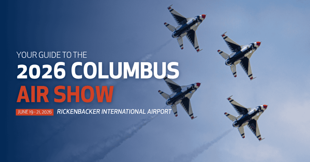 Promotional graphic for the 2026 Columbus Air Show. Four United States Air Force Thunderbirds jets fly in formation across a blue sky, leaving white smoke trails behind them. Large text on the left reads, “Your Guide to the 2026 Columbus Air Show.” Additional text highlights the event dates, “June 19–21, 2026,” and location, “Rickenbacker International Airport.” The words “Air Show” appear in bold orange lettering, while the remaining text is white.