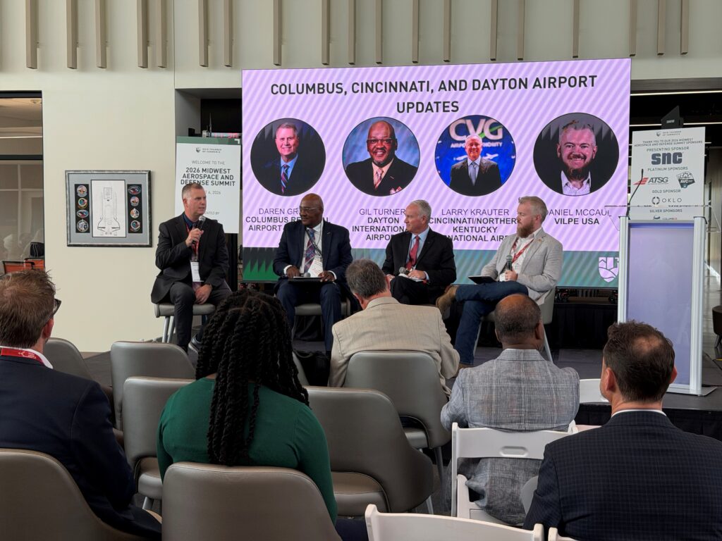 Daren Grifin appears on stage with two other airport leaders for a panel discussion.